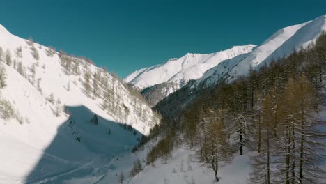 Aerial:-skiers-on-Austrian-Alps-mountain-valley-ski-resort,-Silvretta