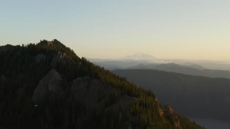 Sunset-over-Kachess-ridge-revealing-distant-Mount-Rainier-in-background,-aerial