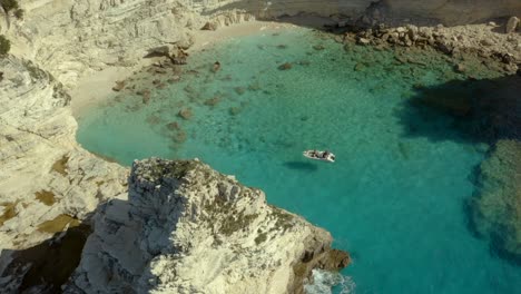 Greece-Tourists-on-Boat-Adventure-in-Mediterranean-Lagoon,-Aerial