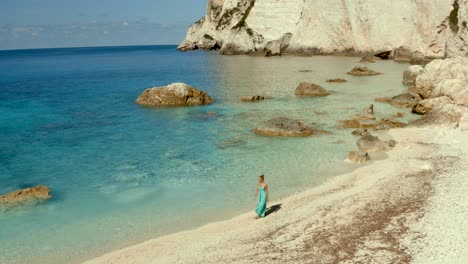 Mujer-Caminando-En-La-Playa-Tropical-Aislada-De-La-Bahía-De-Erimitis-En-Paxos,-Grecia