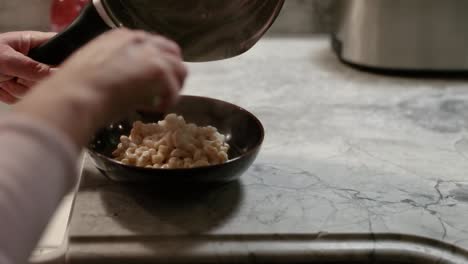 Woman-Serving-Pasta-Into-Bowl-In-Slow-Motion