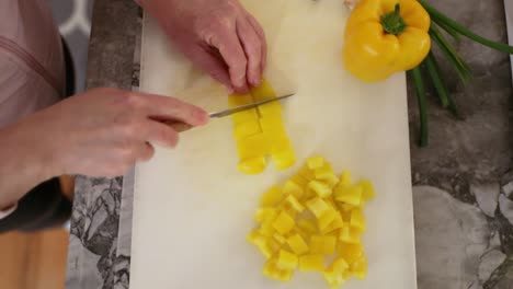 Top-Down-View-Of-Women-Cutting-Pepper-Slices-In-Slow-Motion