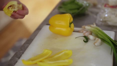 Woman-Coring-A-Pepper-On-Cutting-Board-In-Slow-Motion