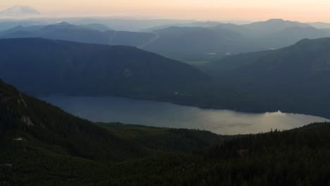 Kachess-lake-between-mountains-during-sunset-in-America,-aerial-going-sideways