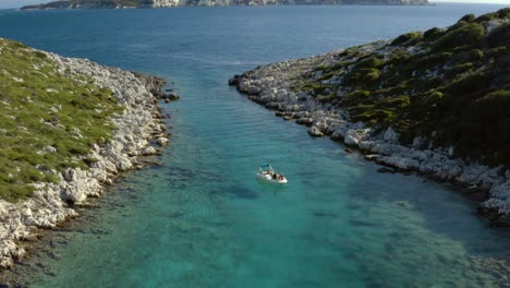 Boat-in-Ionian-Sea-Lagoon-on-Paxos-Island-Coast-in-Greece,-Aerial