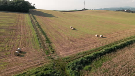 Hay-Bales-On-Vast-Farmland-After-Harvest-On-A-Sunny-Summer-Afternoon-At-The-Countryside-In-Italy