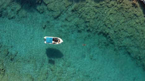One-Person-Tourist-Swimming-in-Greece-Island-Ocean,-Aerial