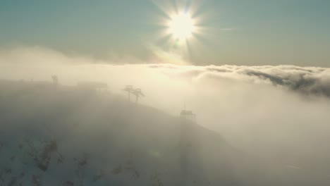 Epic-Aerial-View-of-Ski-Slope-Mountain-above-the-Clouds-in-Russia