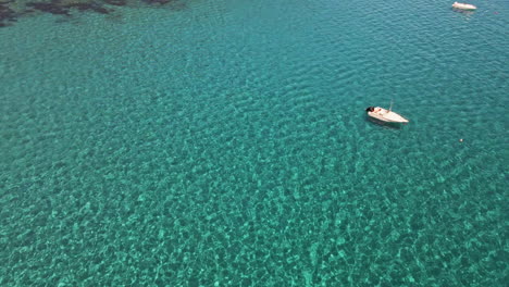 Flying-Above-Crystal-Clear-Emerald-Water,-Mediterranean-Sea-by-Sardinia-Island,-Italy-on-Sunny-Summer-Day,-Drone-Aerial-View