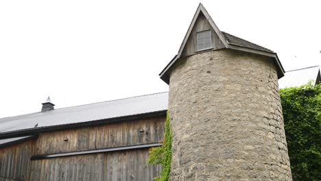 Rural-Wood-Barn-With-Old-Stone-Silo-In-4K