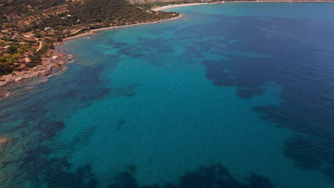Aerial-View-of-Sardinia-Island,-Italy,-Picturesque-Coastline-and-Blue-Waters-of-Mediterranean-Sea,-Tilt-Up-Drone-Shot