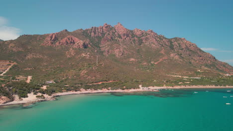 Idyllic-Coast-With-Tropical-Blue-Sea-And-Mediterranean-Rocky-Mountains-During-Summer-In-Sardinia,-Italy---aerial,-wide-shot