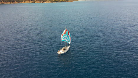 Aerial-View-of-Sailboat-With-Colorful-Sails-in-Blue-Water-of-Mediterranean-Sea