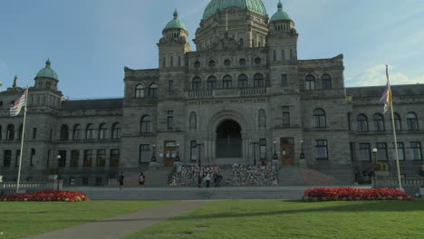 Wide-shot-of-the-BC-Legislative-Assembly-buildings-with-a-memorial-for-Indigenous-Children-victims-on-the-front-steps-in-Victoria-BC