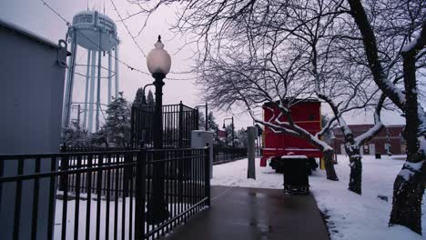 Snow-day-on-walkway-to-train-station-near-water-tower