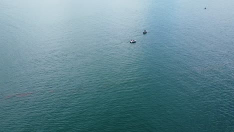 Drone-flying-away-from-fishing-boats-on-the-ocean