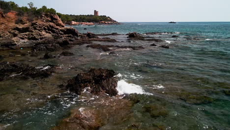 Waves-Crash-Onto-Outcrops-At-Shoreline-On-Summer-In-Sardinia,-Italy