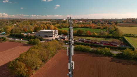 Cinematic-Shot-Of-A-Telecommunication-Tower-At-The-Field-In-The-Country-Outskirts-During-Autumn