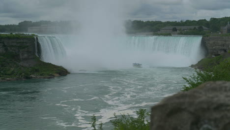 Wide-shot-of-the-Maid-of-the-Mist-tour-boat-in-front-of-the-Canadian-Horseshoe-Falls-in-Niagara