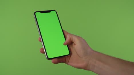 Hand-swipes-to-accept-call-on-phone-with-chroma-green-in-front-of-green-screen