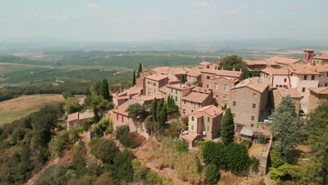 Historical-Settlement-On-Cliff-With-Lush-Farmland-On-Background-At-Sant'Angelo-In-Colle,-Montalcino-Siena,-Tuscany,-Central-Italy