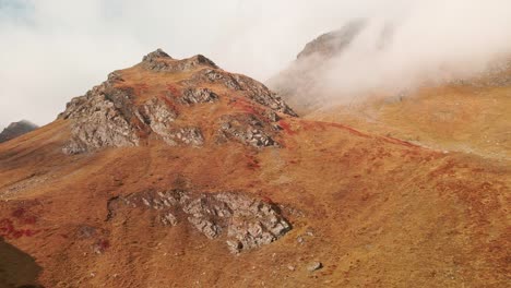 Rocks-On-Mountain-Peak-Against-Misty-Horizon-During-Autumn-In-Piemonte,-Italy
