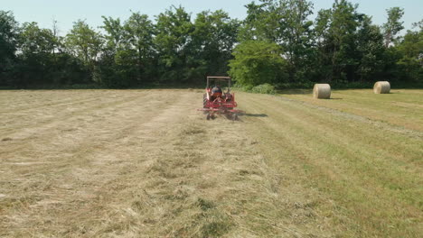 Farmer-Works-On-Tractor-Making-Hay-For-Harvesting-During-Summer-In-Italy