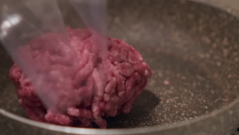 Person-Put-Raw-Minced-Beef-From-A-Plastic-Packaging-Into-Frying-Pan