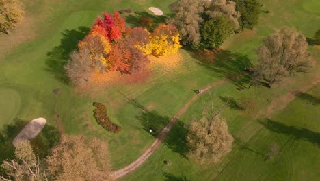 Golf-Course-With-People-Walking-On-Dirt-Road-Moving-Hole-To-Hole-During-Autumn-Season