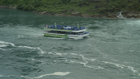 Maid-of-the-Mist-tour-boat-travels-up-the-Niagara-River-towards-the-falls