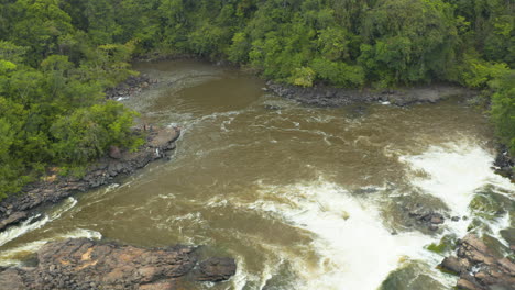 Drone-shot-looking-over-a-river-waterfall-in-the-jungles-of-Guyana