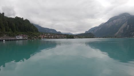 Unrecognizable-person-rowing-boat-on-Brienz-lake,-Switzerland-on-cloudy-day