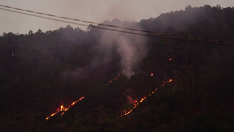 Wildfire-Raging-on-the-Side-of-a-Mountain-of-Trees-in-Vietnam-with-Smoke-Billowing-Upwards
