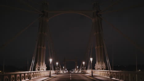 Empty-street-bridge-over-River-Thames-in-London-at-night,-England