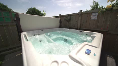 Slow-wide-push-in-of-private-hot-tub-jacuzzi-at-vacation-rental-in-summer