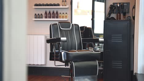Side-to-side-reveal-of-leather-barber-shop-in-hair-stylist-business