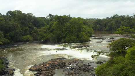 Stunning-aerial-shot-overlooking-a-small-waterfall-in-the-Guyana-jungle