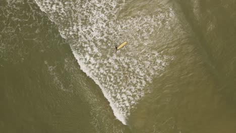 Slow-motion-of-isolated-and-unrecognizable-surfer-entering-ocean-water