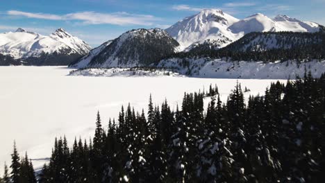 Grandiose-Aerial-Shot-of-snow-covered-frozen-Garibaldi-Lake-in-Winter