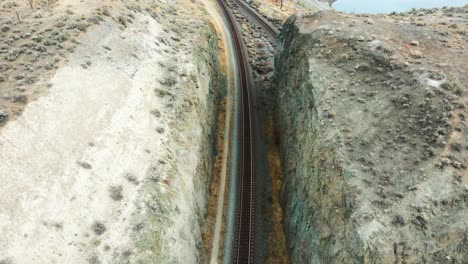 overhead-shot-of-the-railroad-lines-along-Kamloops-Lake-in-a-desert-environment-in-the-Nicola-Thompson-Region-in-BC-Canada