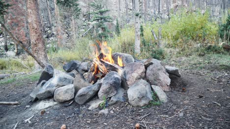 Day-time-campfire-surrounded-by-many-rocks-for-protection