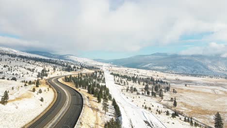 Vehicles-moving-on-the-Coquihalla-Highway-5-between-Merritt-and-Kamloops-on-a-cloudy-day-in-the-winter