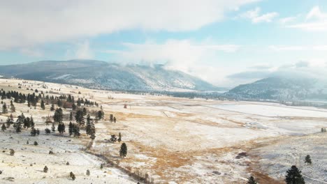 Wide-Shot-of-the-Grasslands-of-the-Nicola-Valley-covered-in-light-snow-on-a-partly-cloudy-day-in-the-winter-with-sunshine-in-Merritt,-BC-Canada