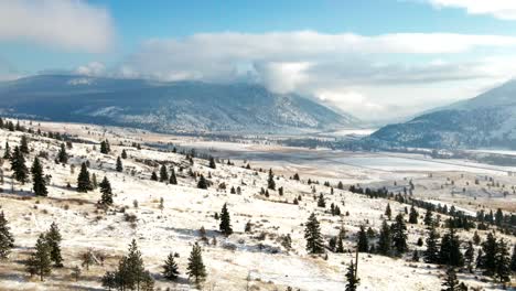 Panoramic-Scene-of-Grasslands-and-mountains-of-the-Nicola-Valley-covered-in-light-snow-on-a-partly-cloudy-day-in-the-winter-with-sunshine-in-Merritt,-BC-Canada