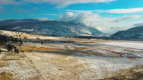 Hyperlapse-of-the-Grasslands-of-the-Nicola-Valley-covered-in-light-snow-on-a-partly-cloudy-day-in-the-winter-with-sunshine-in-Merritt,-BC-Canada