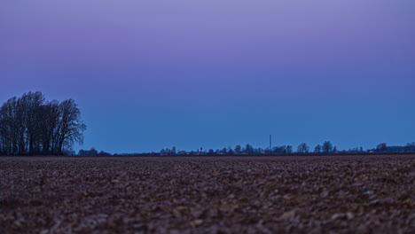 Ground-Level-Shot-On-Rural-Rural-Field-With-Blue-Twilight-Sky-Turning-Purple