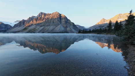 Steam-Fog-Over-Bow-Lake-With-Reflections-Of-Crowfoot-Mountain-Within-The-Banff-National-Park-in-Alberta,-Canada