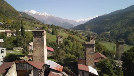 Drone-view-of-residential-and-Caucasus-mountain-in-background,-Svaneti,-Georgia