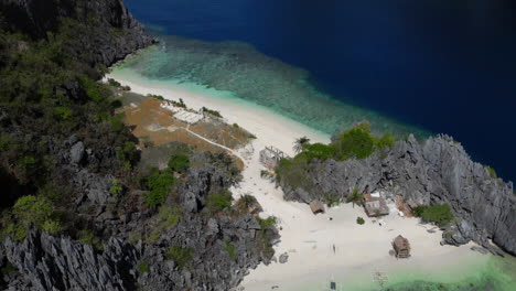 Tilting-area-view-of-private-beach-hidden-by-rocky-cliffs-in-Philippines