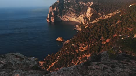Beautiful-drone-shot-of-nature-and-mountains-on-coast-of-Ibiza,-Spain